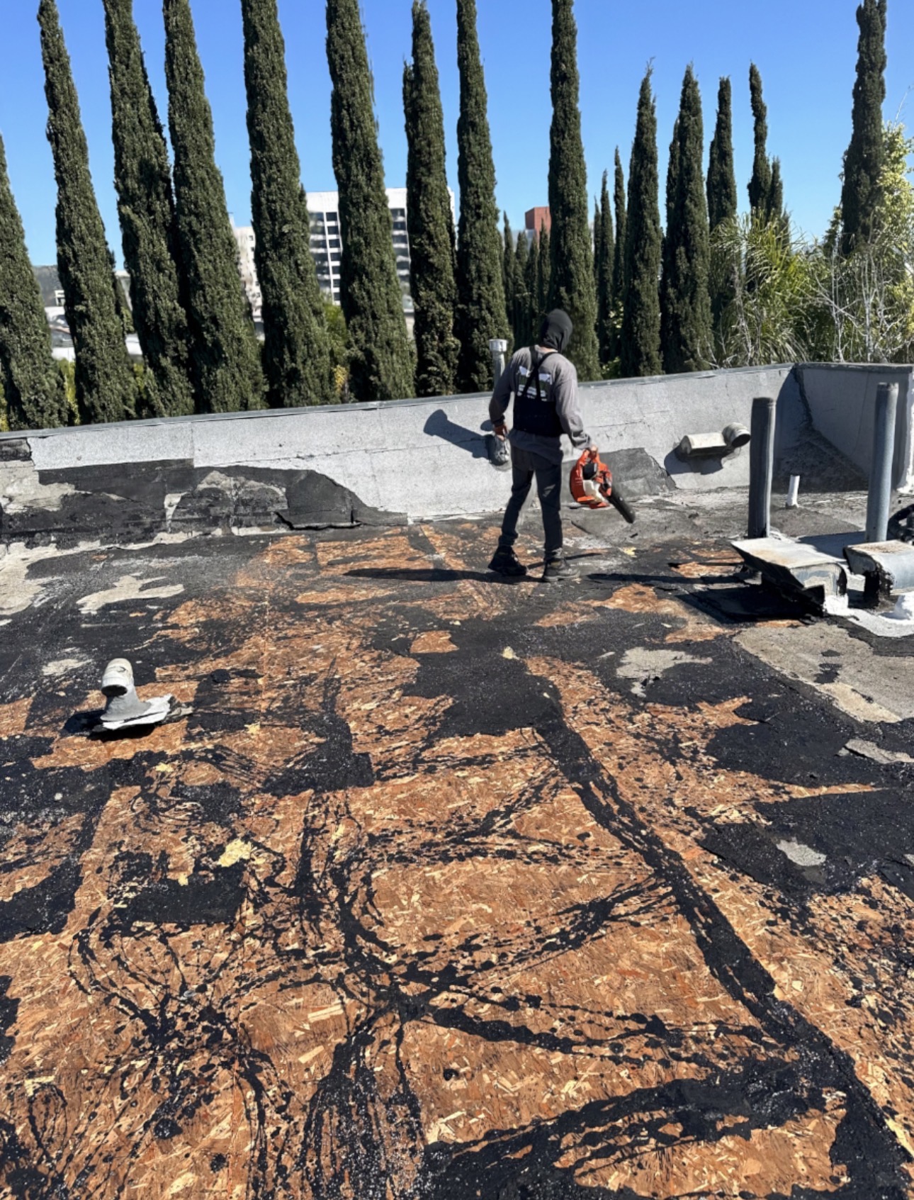 California First Roofing crew stripping an old built-up flat roof in LA