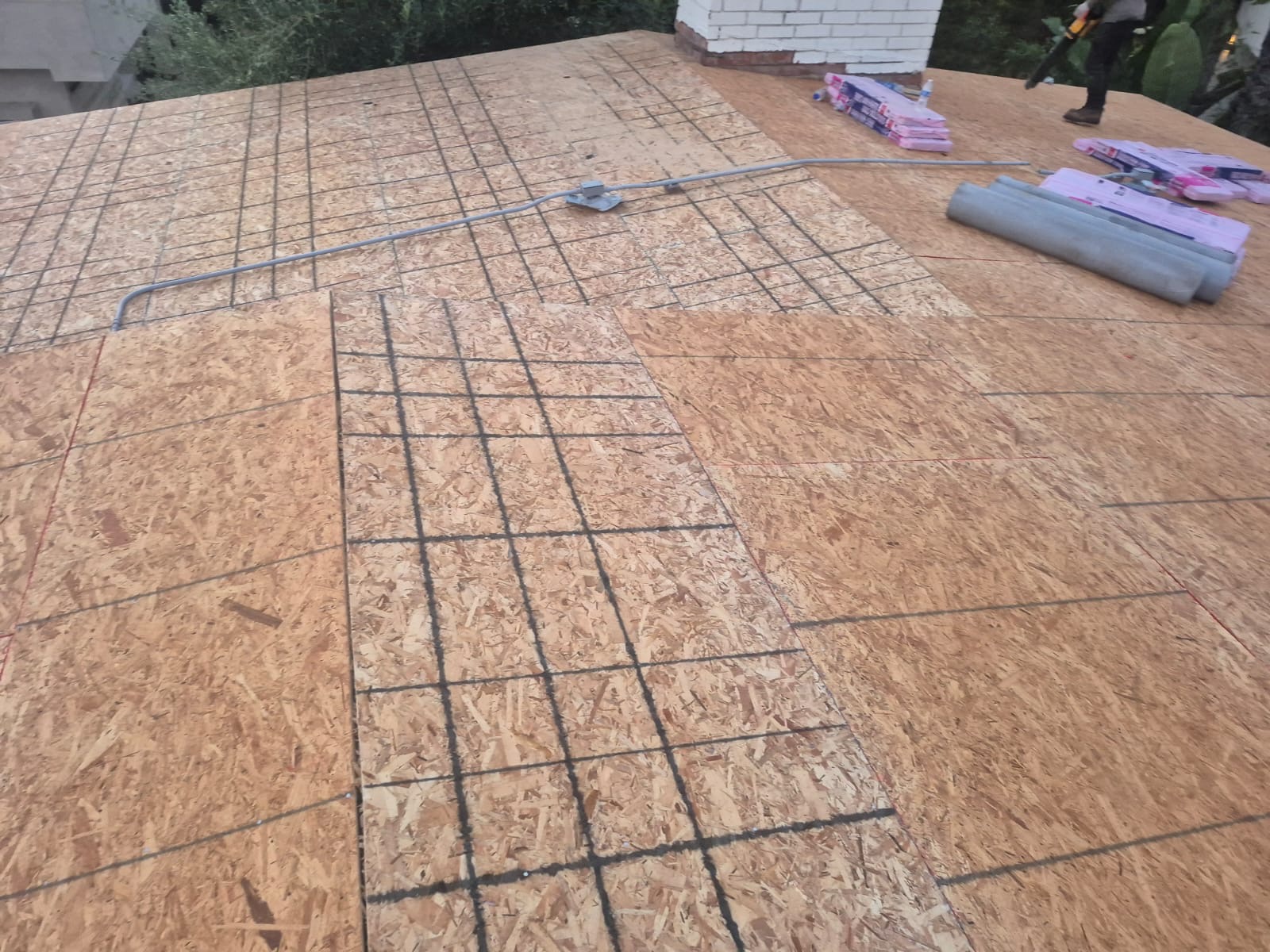 Chalk-lined roof decking prepped for architectural shingle install