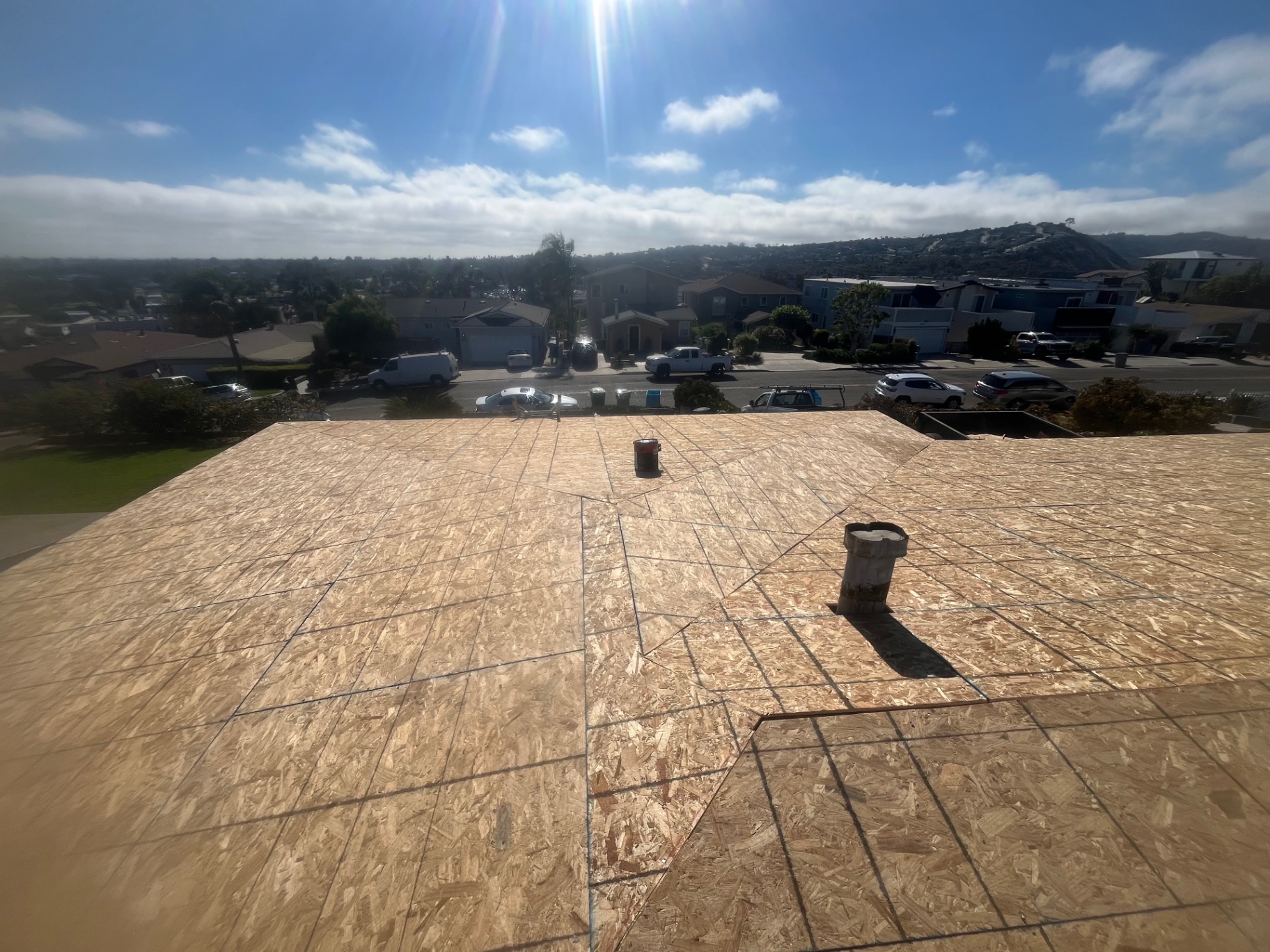 New roof decking with vent pipes ready for shingle installation