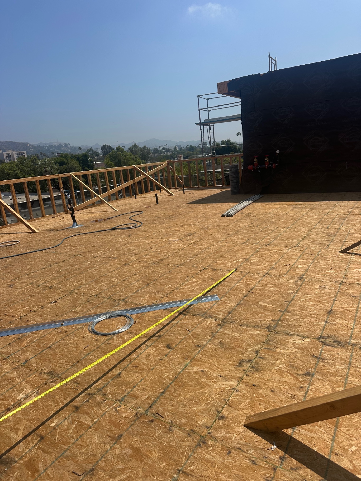 Rooftop deck framing with fresh OSB and city views in Los Angeles