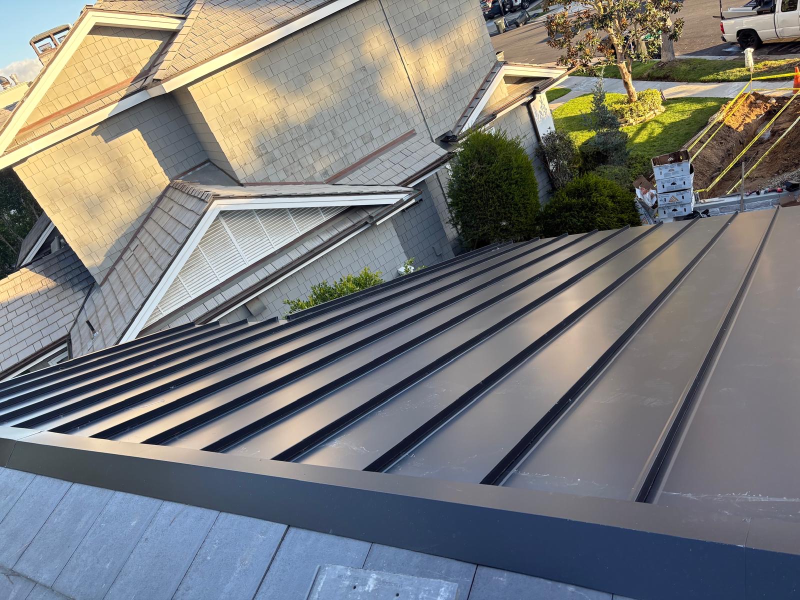 New matte black standing seam metal roof installed on a Los Angeles home