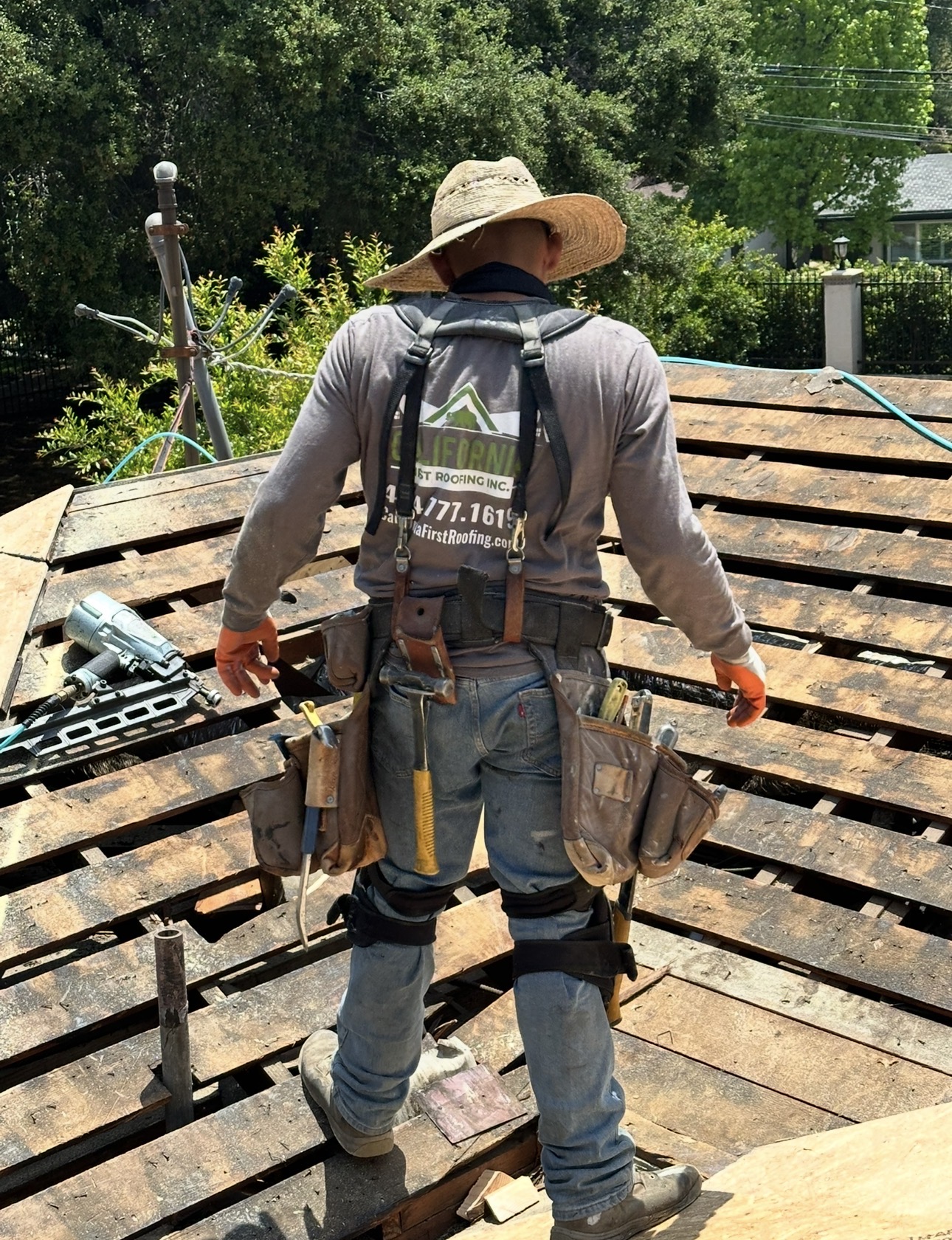 California First Roofing crew member on a residential shake tear-off in Los Angeles