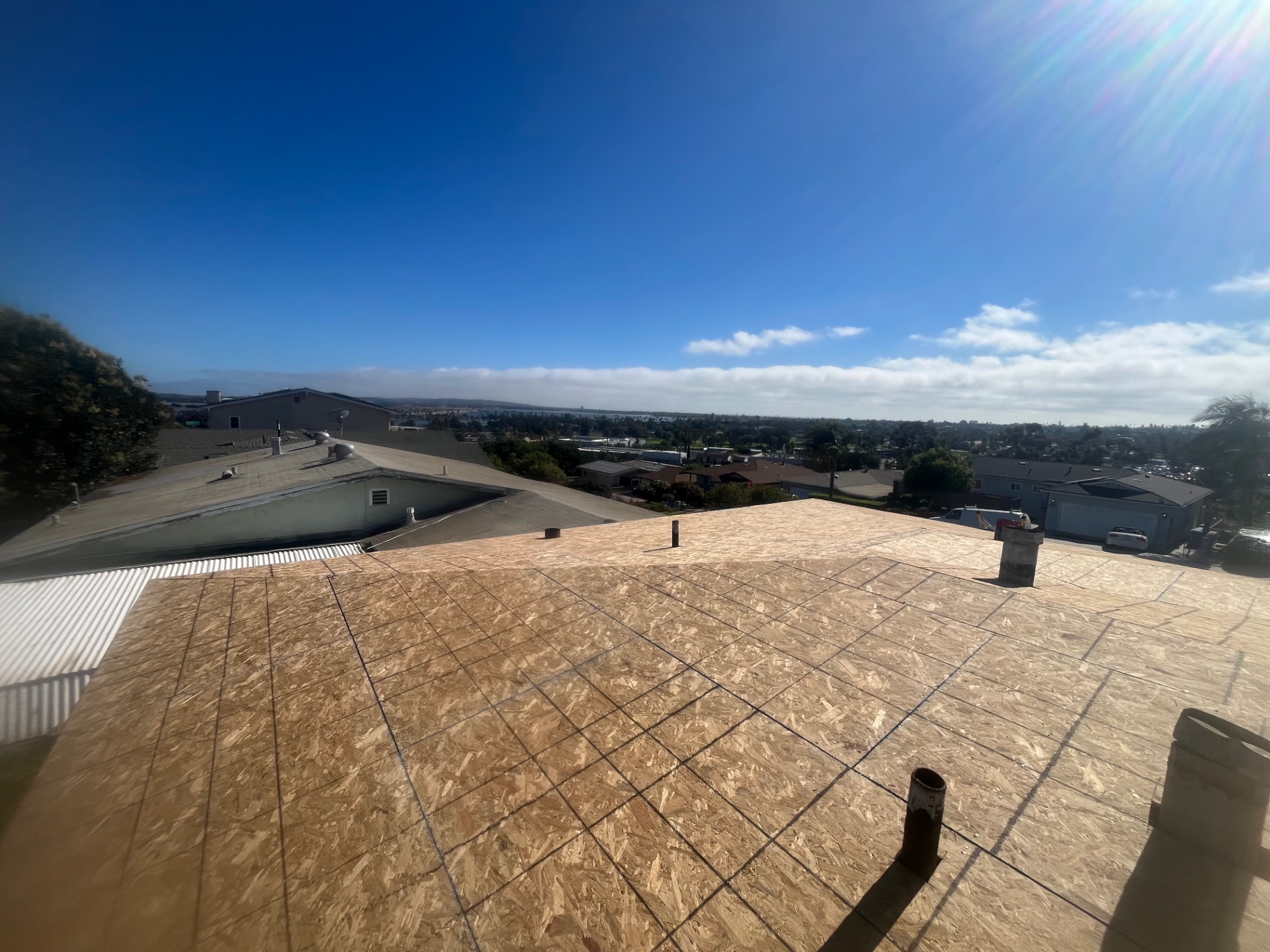Panoramic view from a Los Angeles rooftop mid-project with new decking