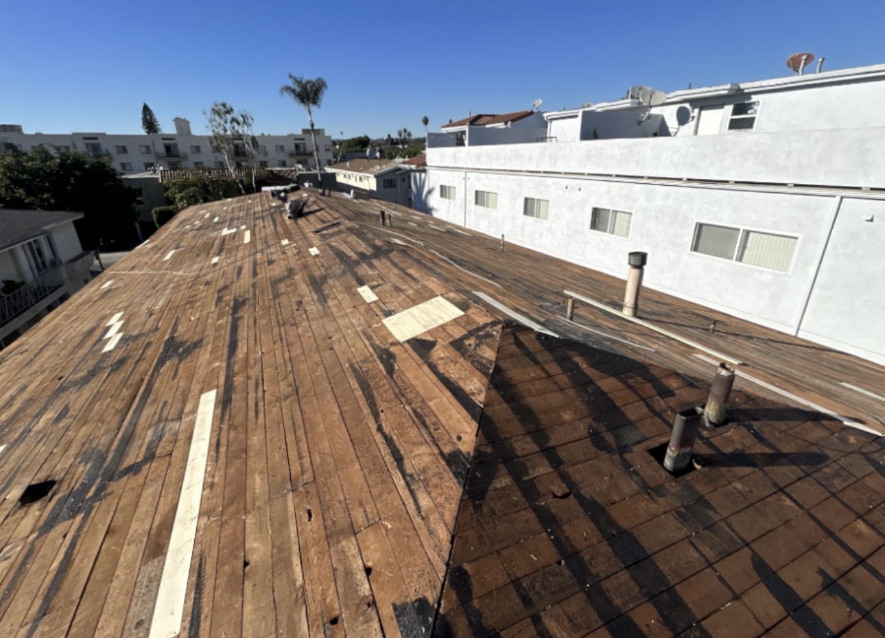 Cedar shake fully stripped exposing original skip sheathing on an LA multifamily building